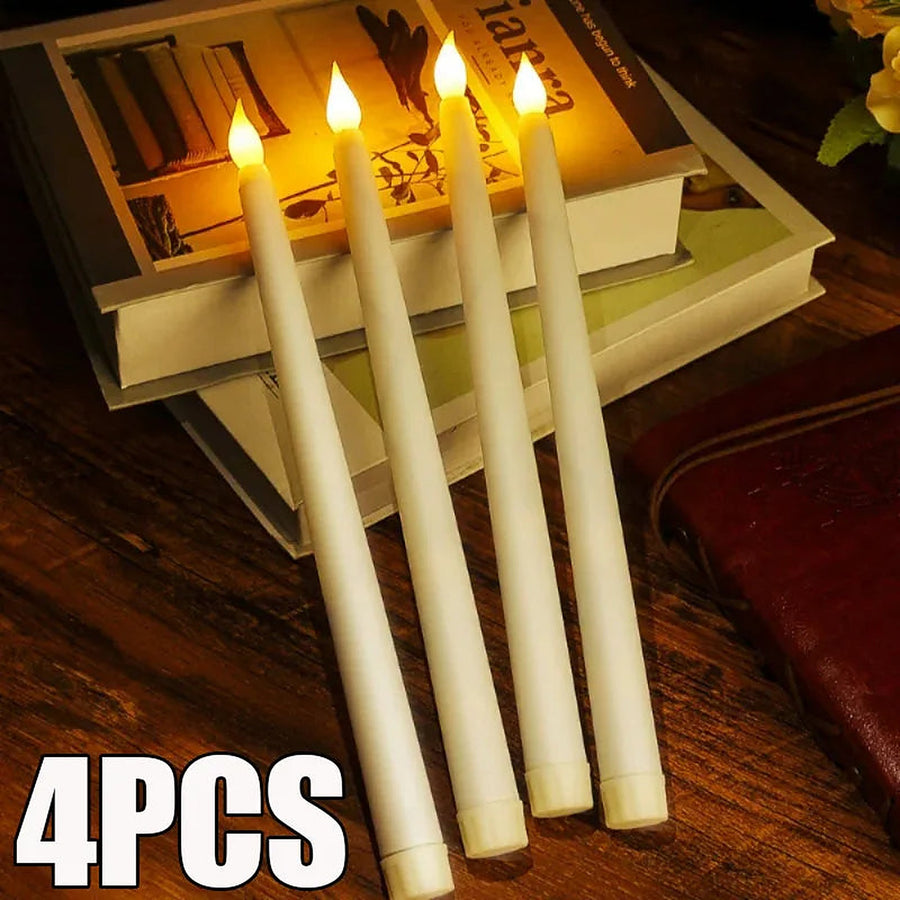 Four flameless LED taper candles glowing on stacked books