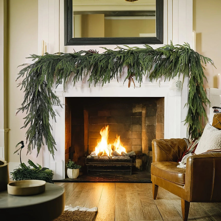 Norfolk pine garland draped over a fireplace mantel