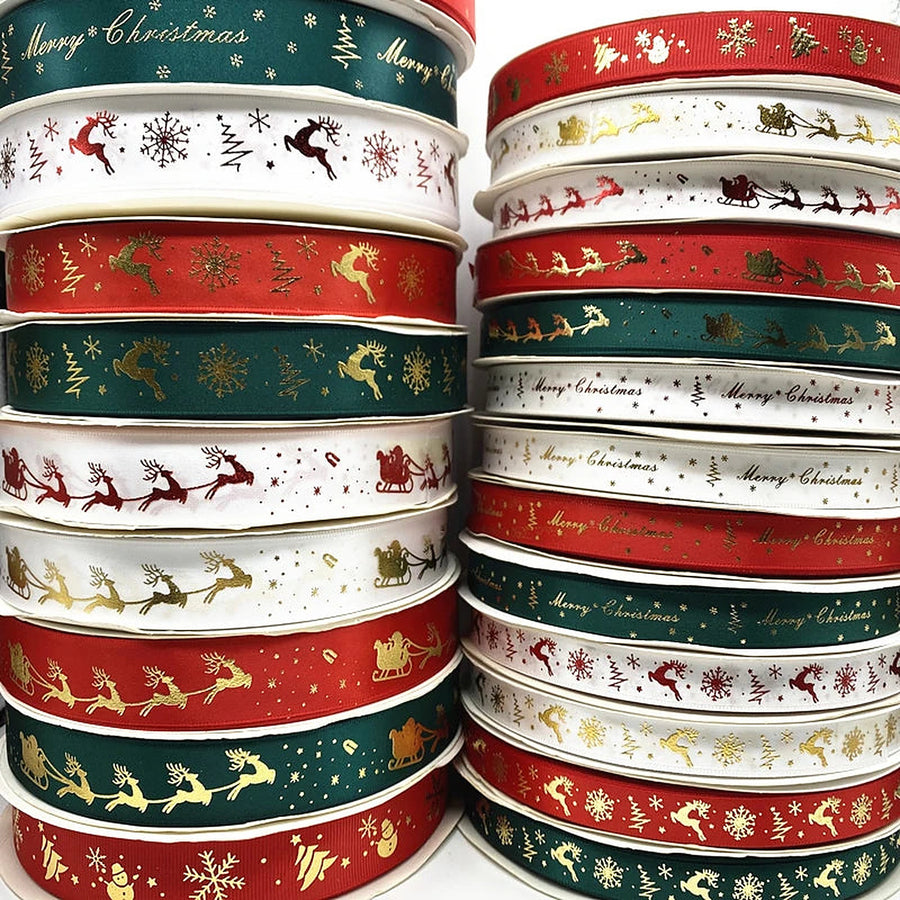 Rolls of printed Christmas ribbon in red, white and green with gold designs