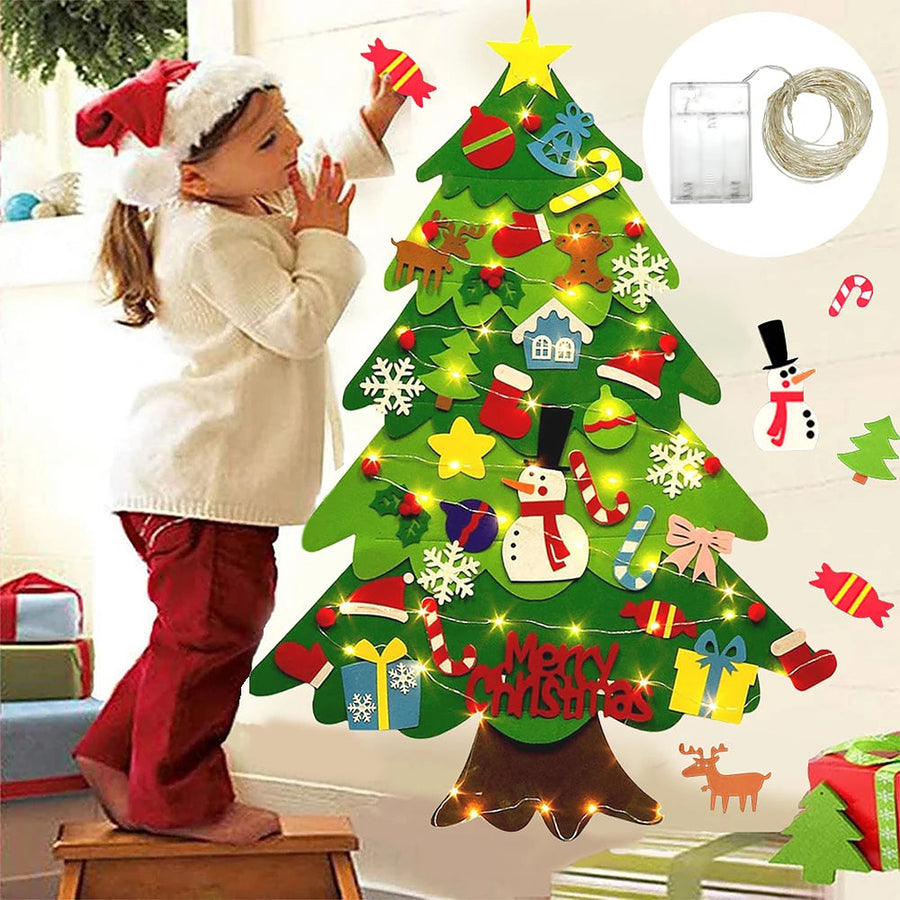 Child decorating a lit felt Christmas tree on the wall