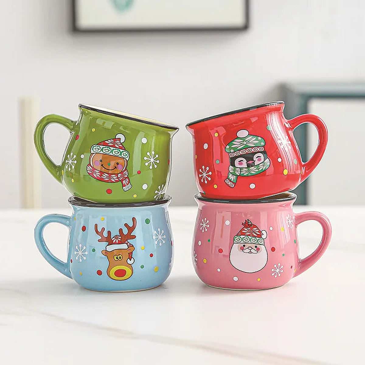 Stacked ceramic mugs with bear, penguin, reindeer and Santa designs