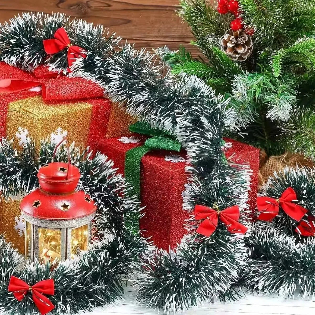 Frosted tinsel garland with red bows around wrapped gifts