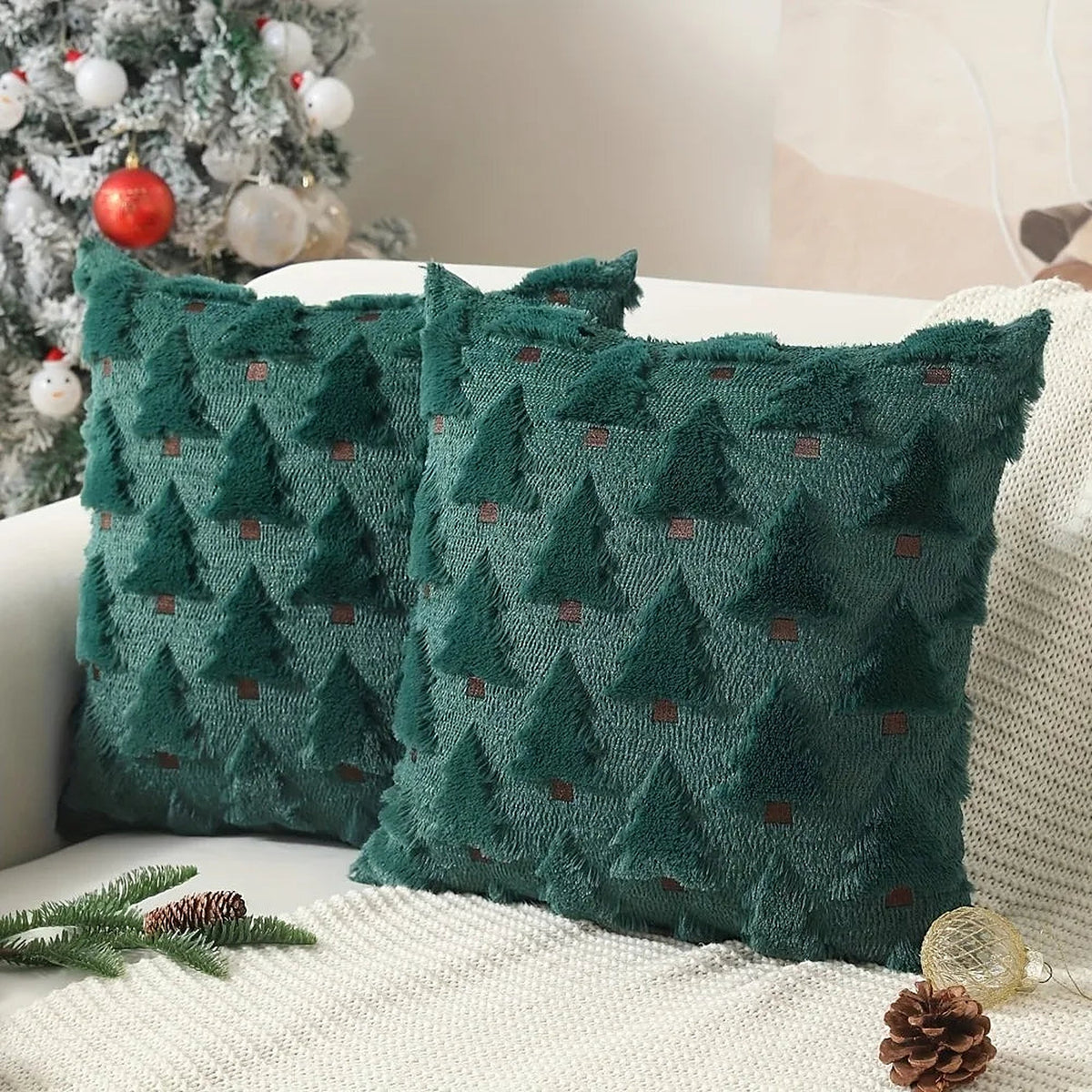 Green Christmas tree pillow covers on a sofa