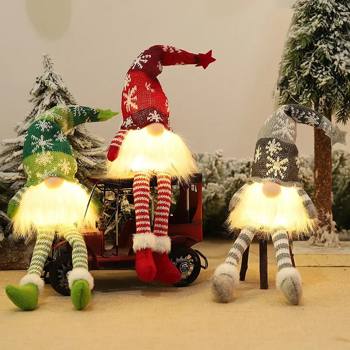 Long-legged knit gnomes sitting on a toy truck