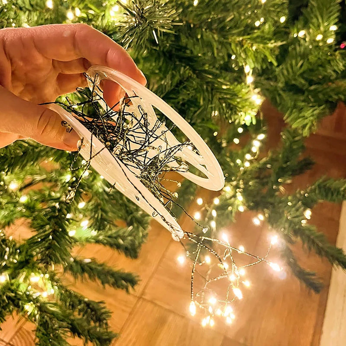 Unwinding cluster lights from the reel onto a tree