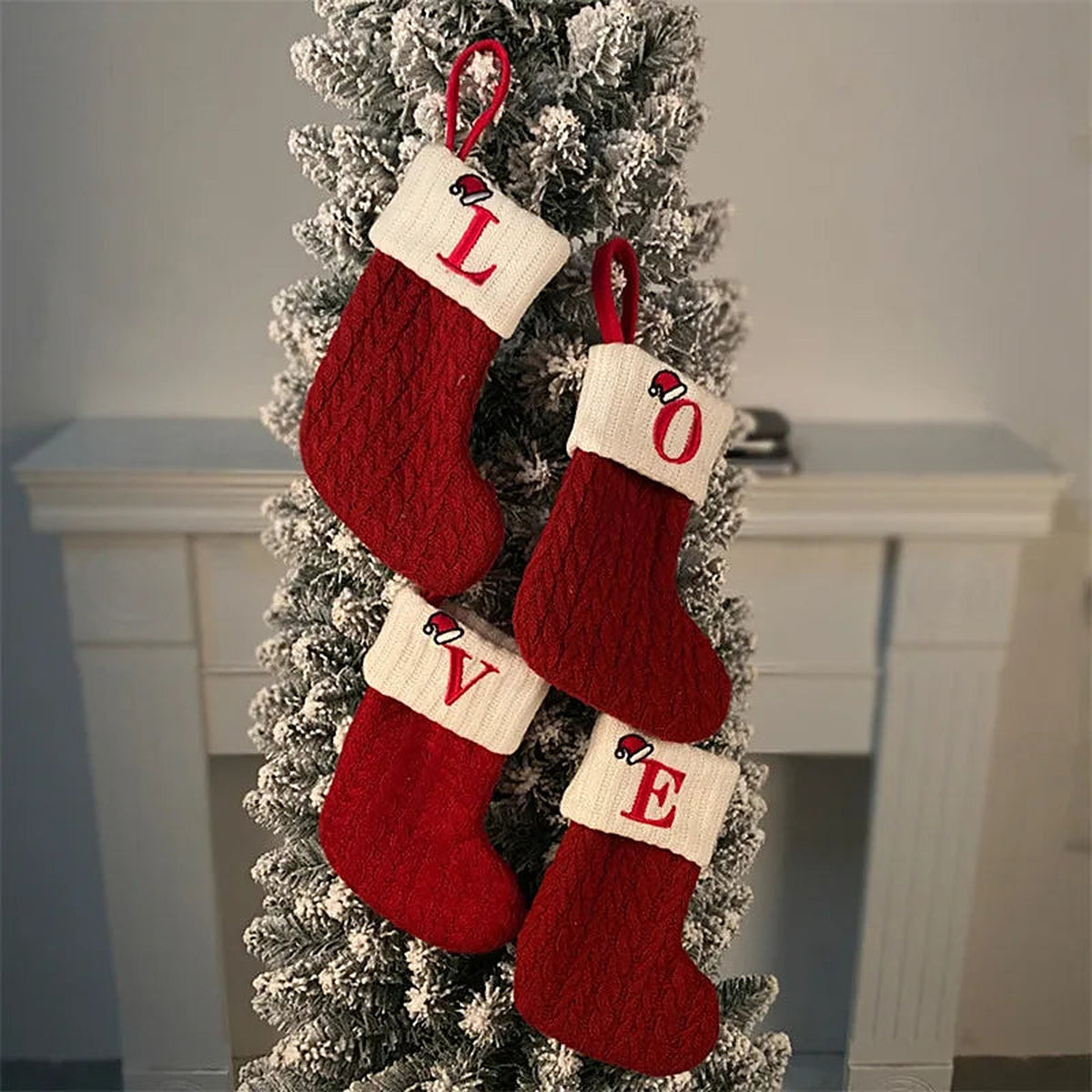 Initial mini stockings spelling L, O, V, E on a Christmas tree