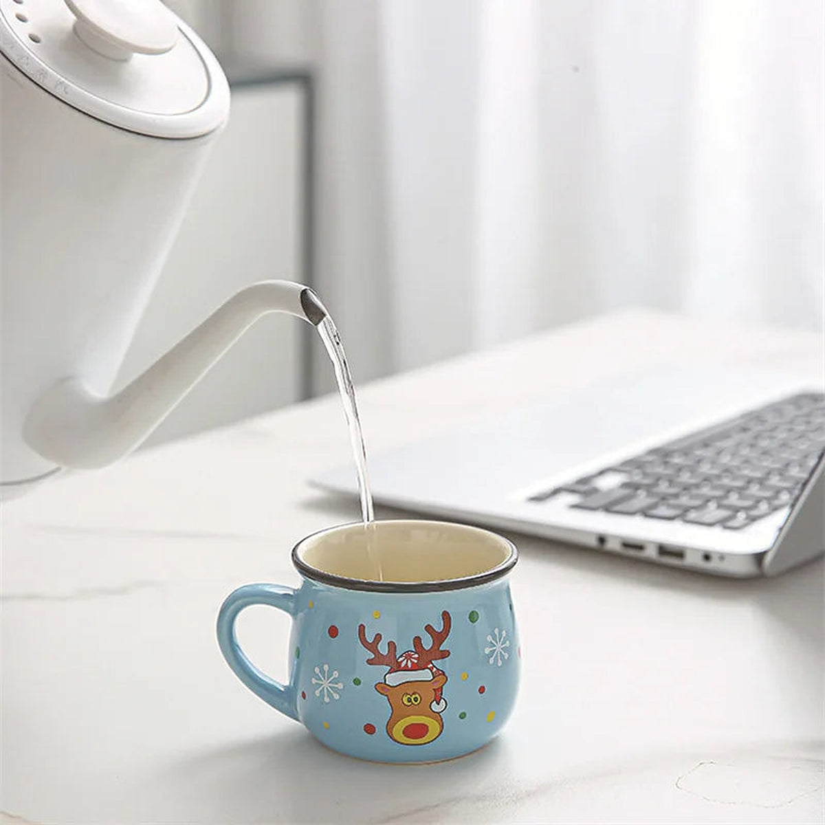 Pouring hot water into a light blue reindeer Christmas mug
