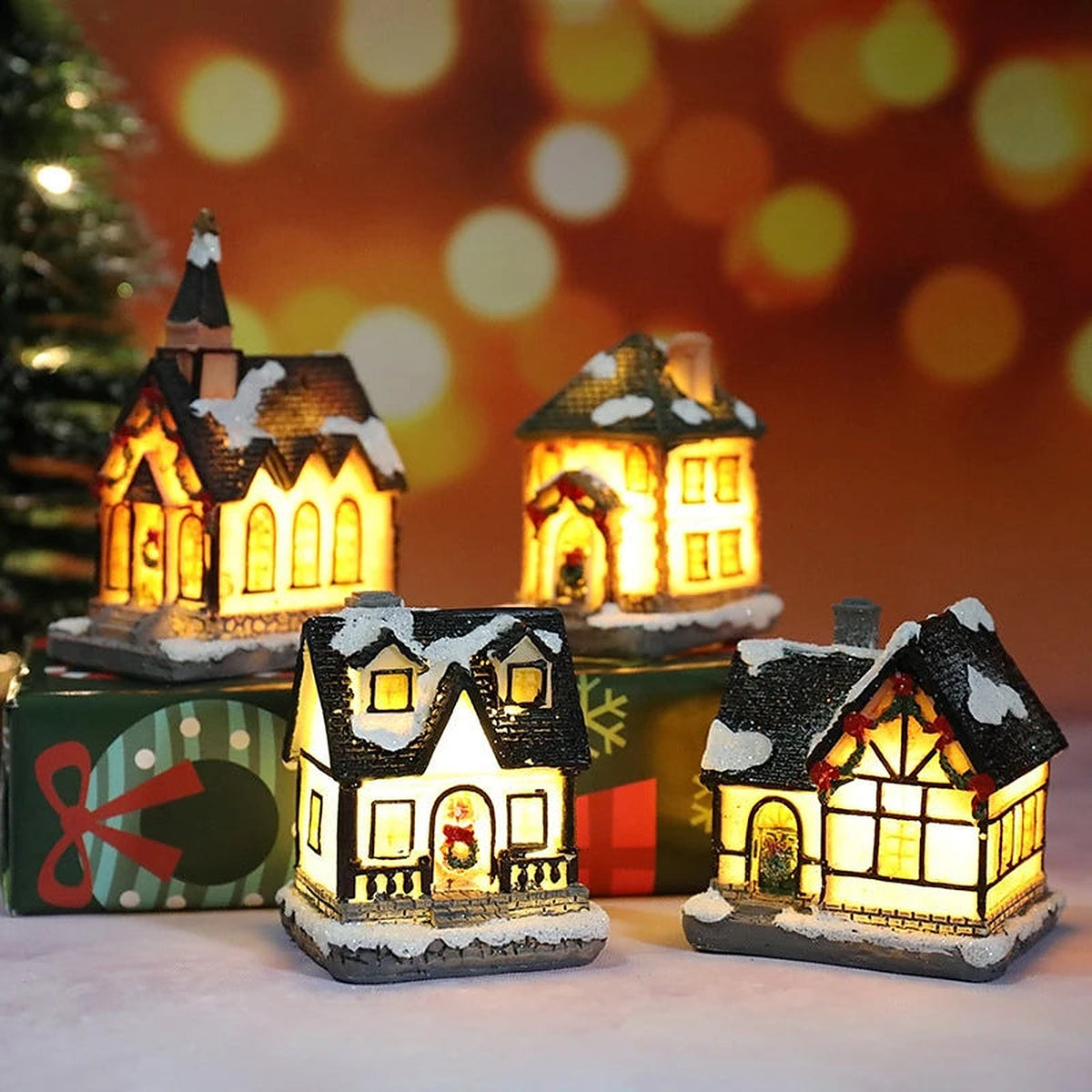 Four glowing village houses on gift boxes