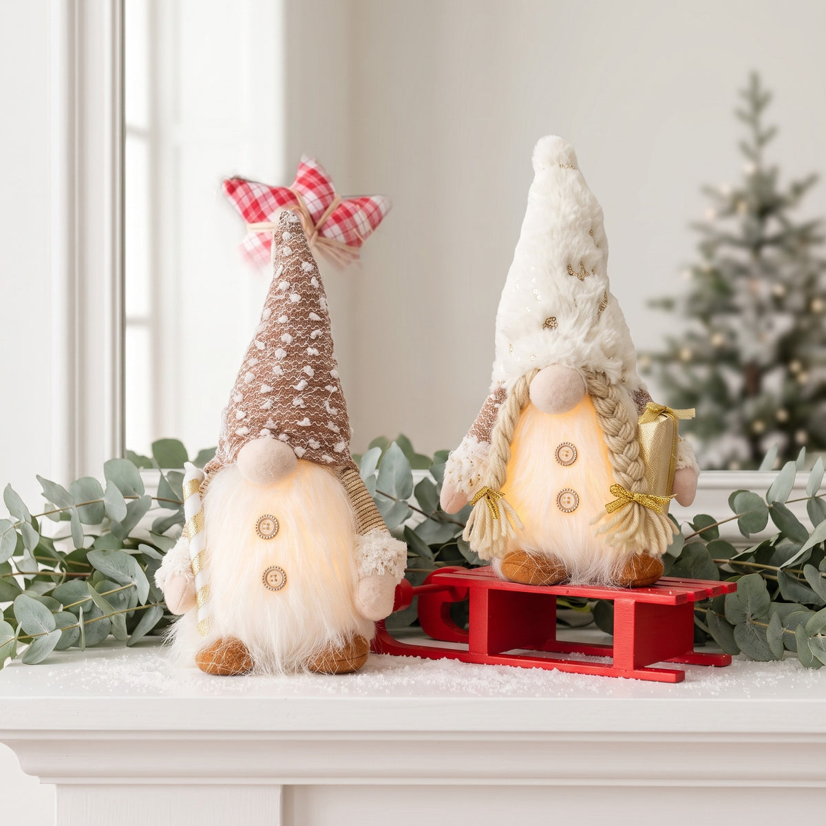 Light-up gnome dolls with bow and snowflake hats on a sled
