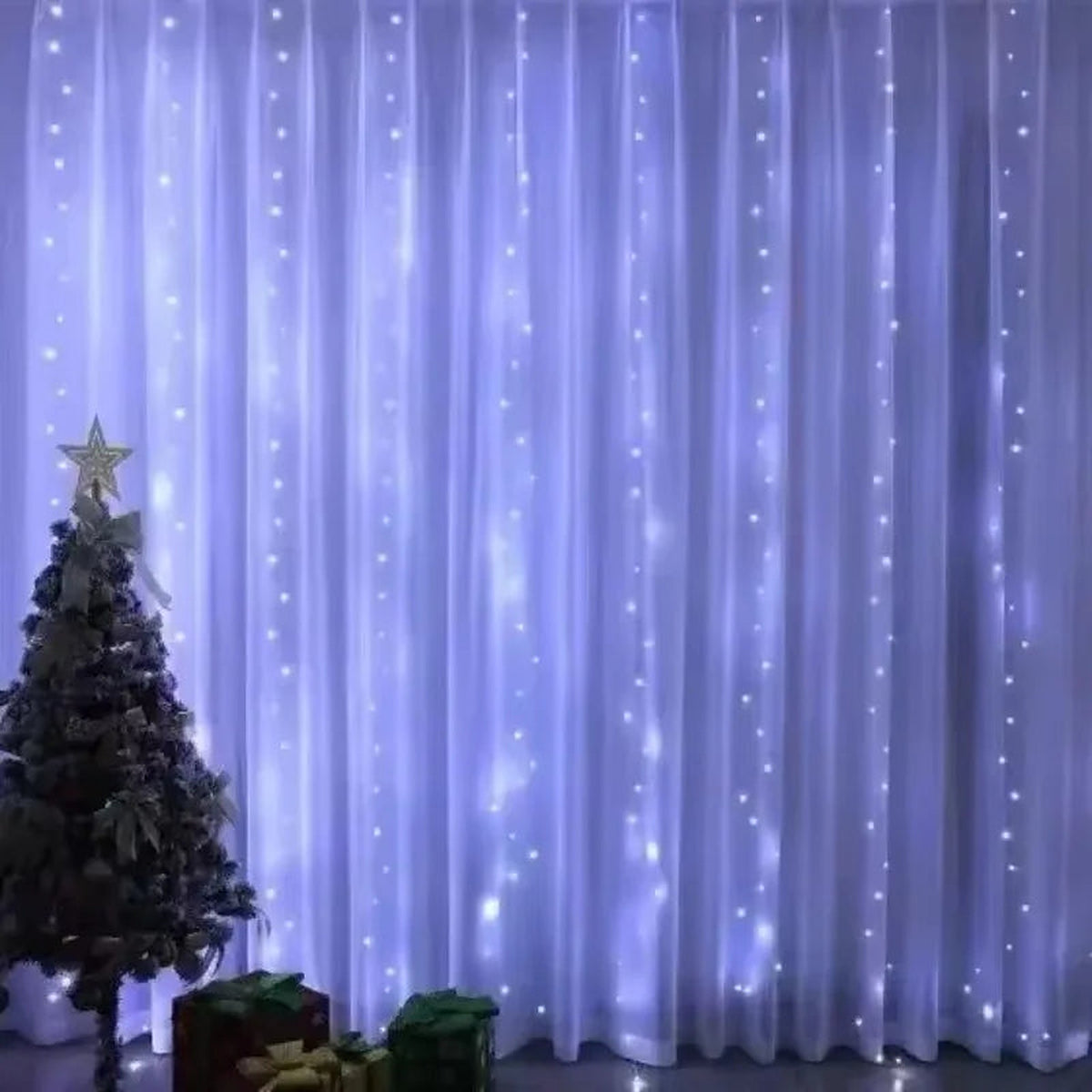 White LED curtain lights behind a Christmas tree