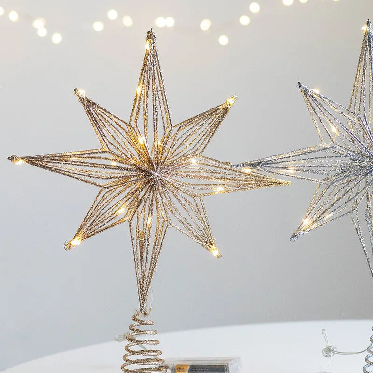Gold light-up 8-point star tree topper, lit