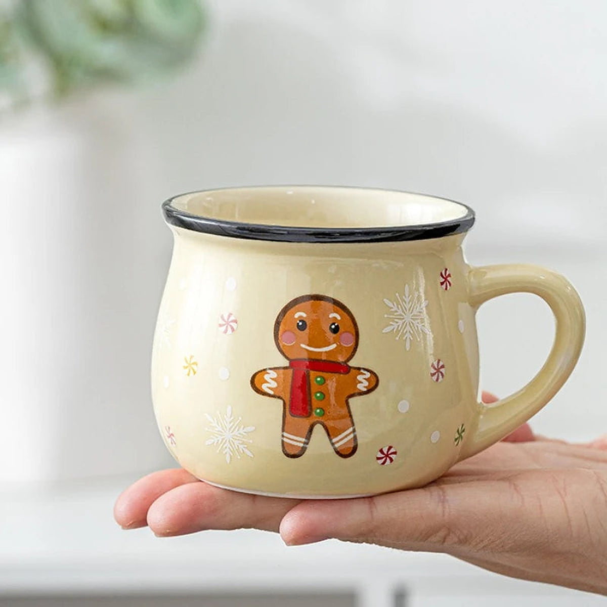Cream gingerbread man ceramic mug held in a hand