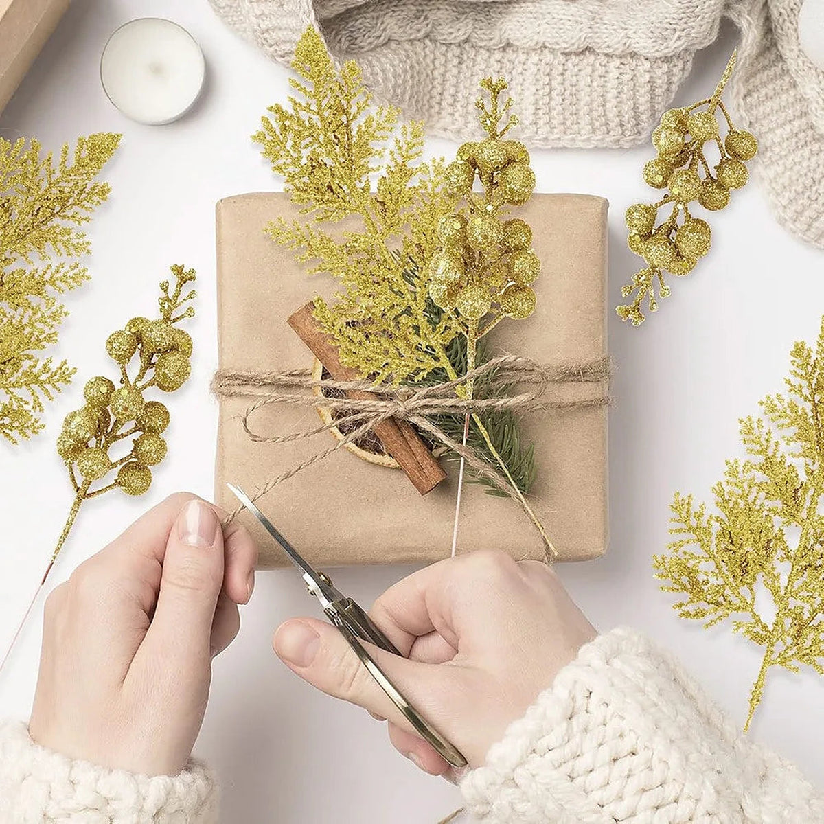 Gold glitter picks tied onto a kraft-paper wrapped gift