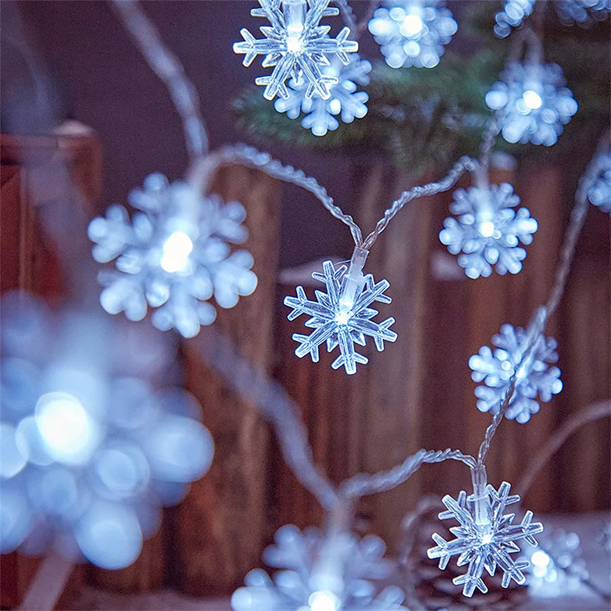 Cool white LED snowflake string lights glowing
