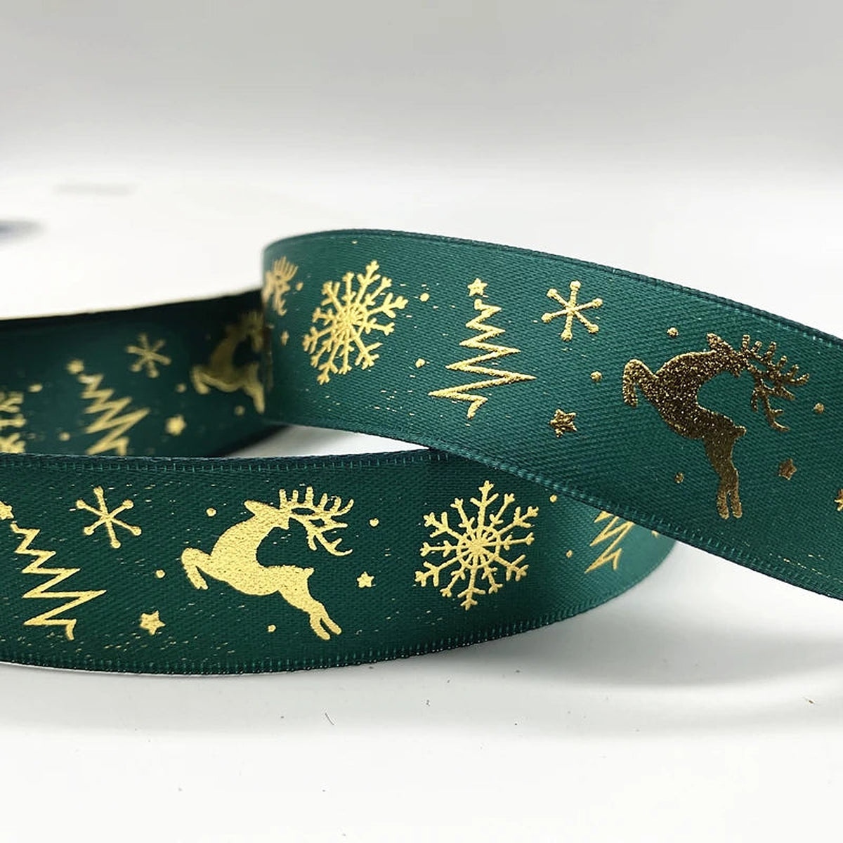 Green ribbon with gold reindeer, trees and snowflakes