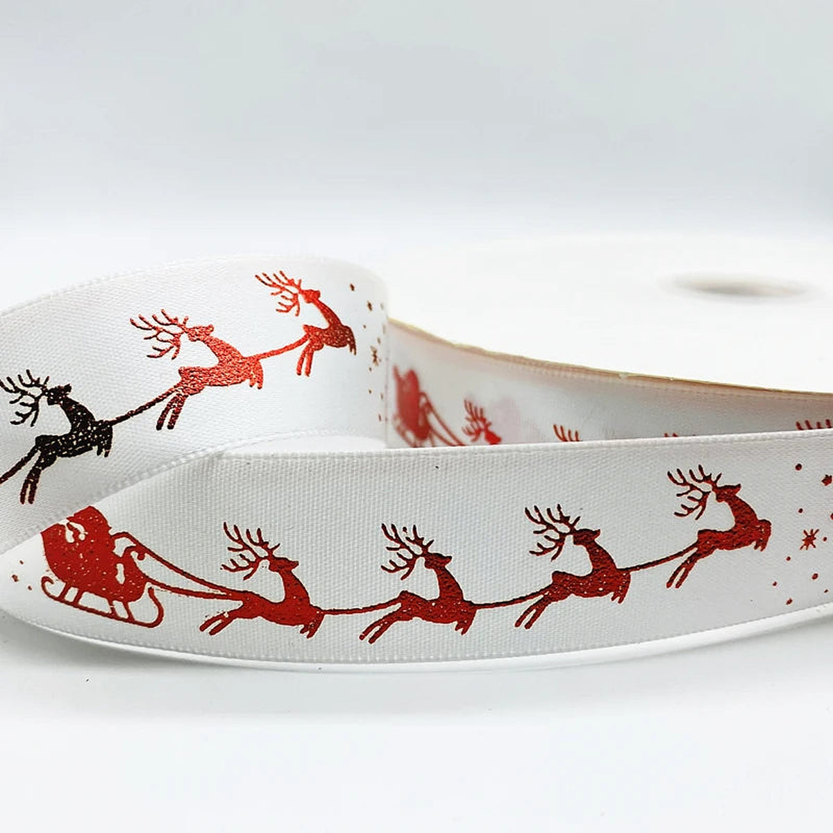 White ribbon with red sleigh and reindeer