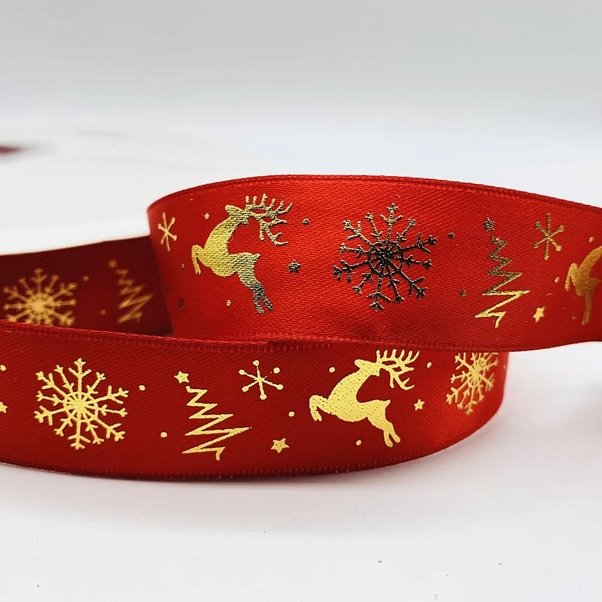 Red ribbon with gold reindeer, trees and snowflakes