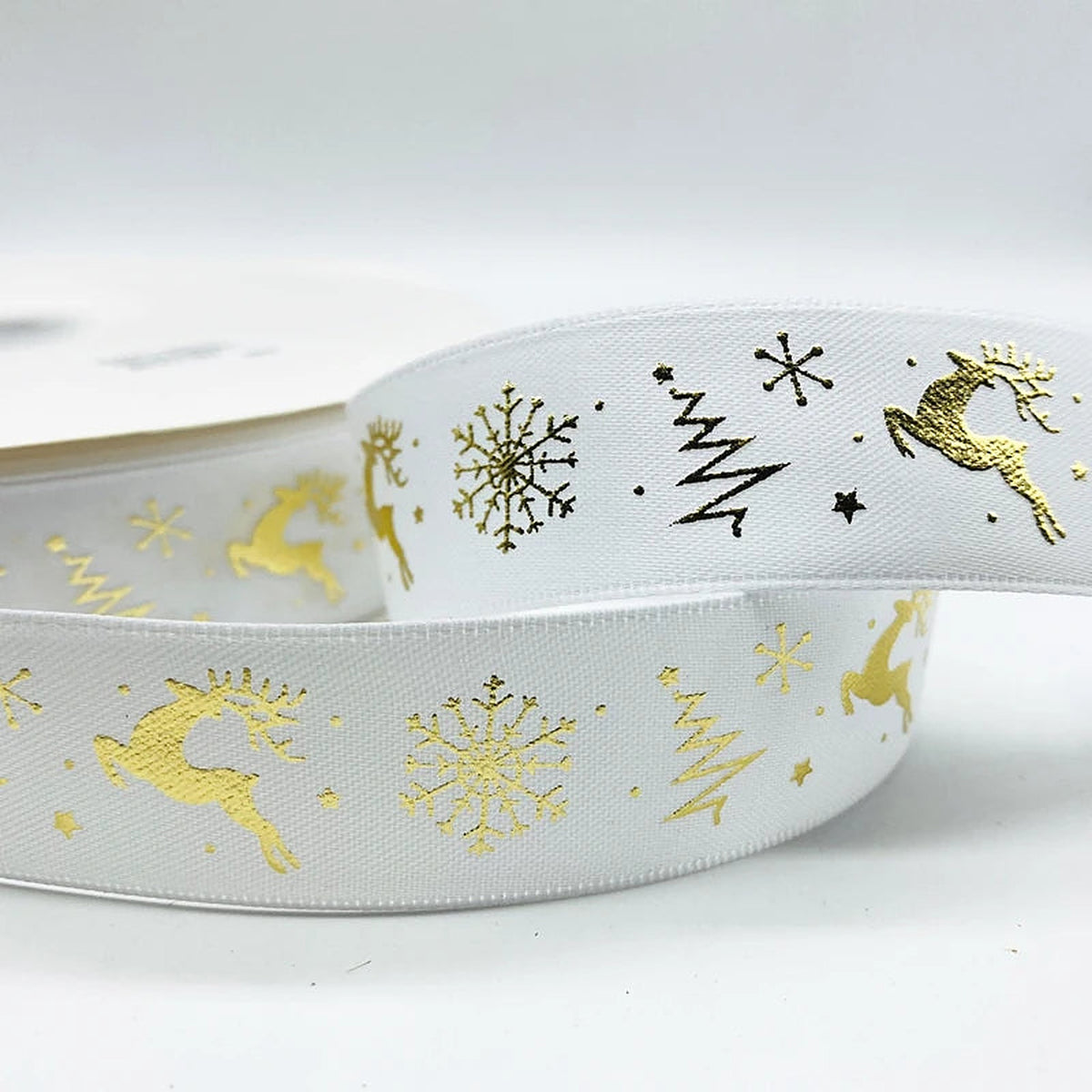 White ribbon with gold reindeer, trees and snowflakes